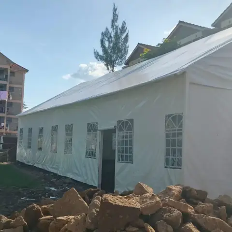 White dome tent structure installed on a residential plot
