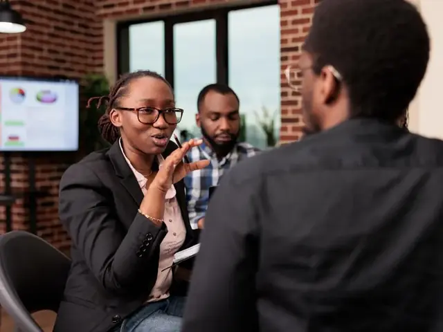 Colleagues discussing business plans around a table