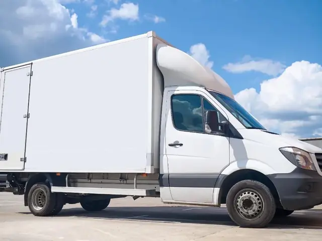 Delivery truck parked in an open lot ready for dispatch