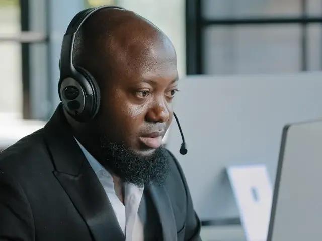 Manager reviewing after-sales support processes on a laptop